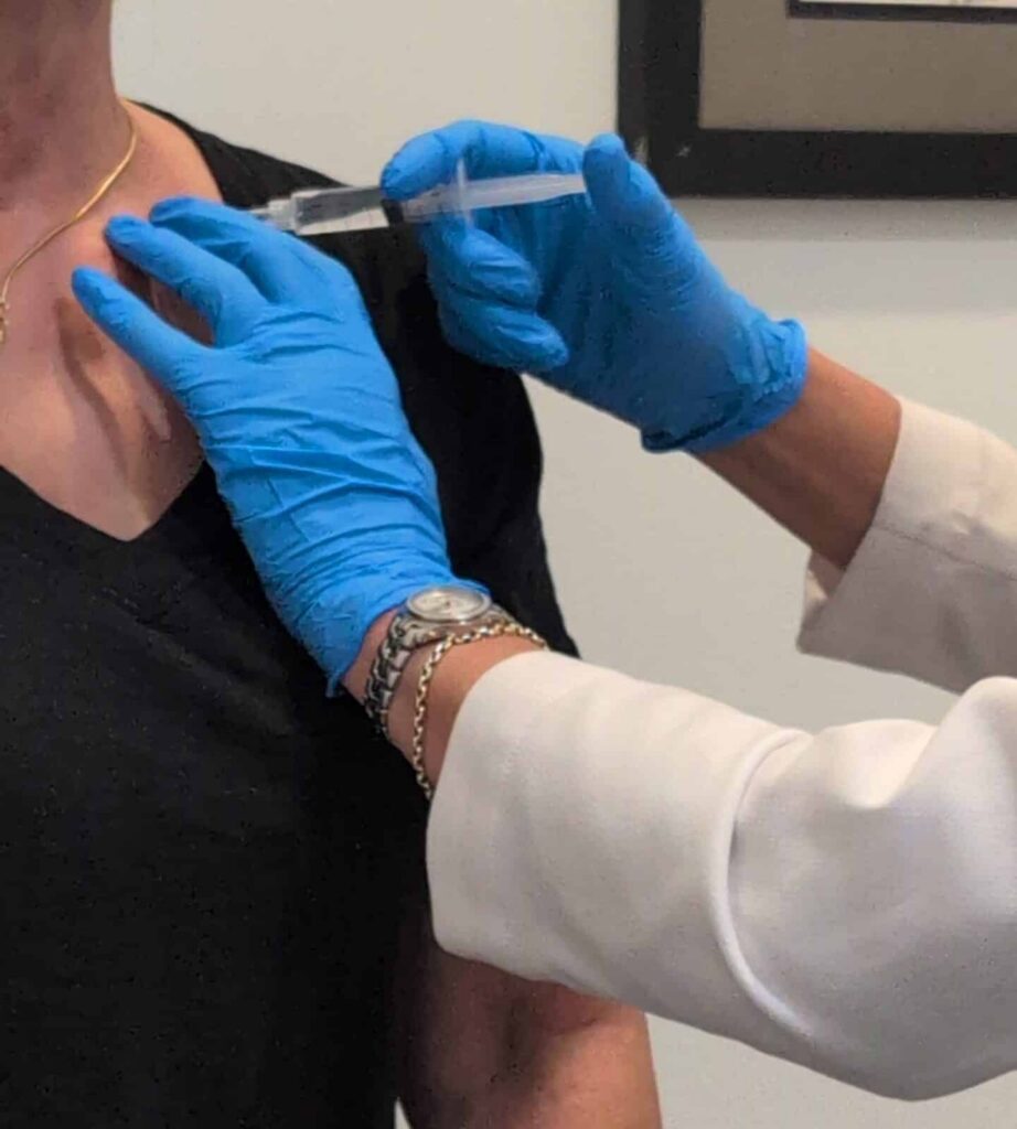 Dr Mary injecting Procaine in a patient at the remedy room