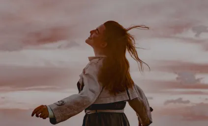 A woman experiencing joy following her O-Shot procedure