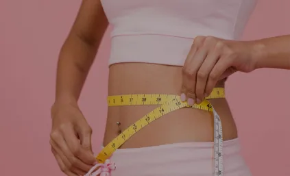 A woman checking her belly size following weight loss
